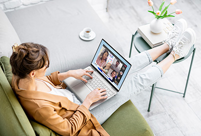 Girl at her couch using an HP Spectre to have a video call