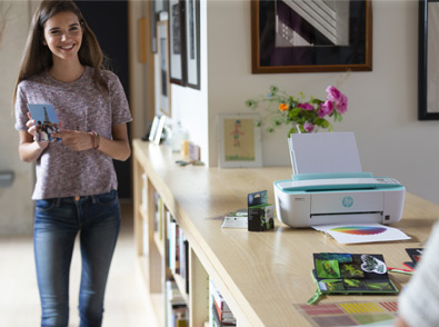 image of a girl with a printout in her hand standing by printer