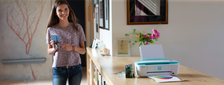 image of a girl with a printout in her hand standing by printer