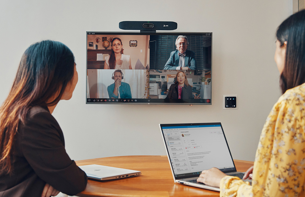 people having video conference in a meeting room.