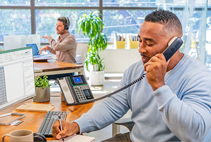 person having a meeting over the internet using a poly phone