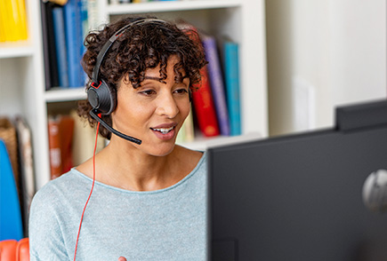 person having a meeting over the internet using a poly USB headphone